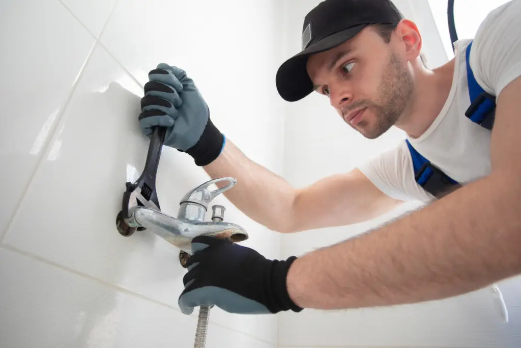 man fixing the faucet